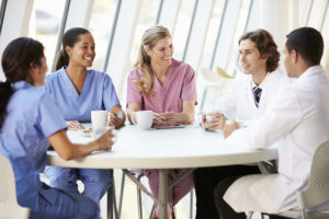 Medical Staff Chatting In Modern Hospital Canteen