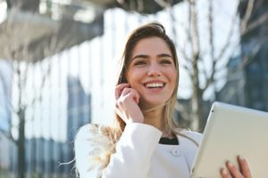 smiling successful person on phone with tablet