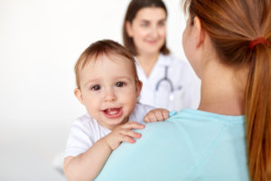 medicine, healthcare, pediatry and people concept - close up of happy baby with mother and doctor at clinic