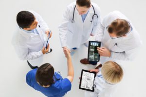 Doctors looking at digital patient data