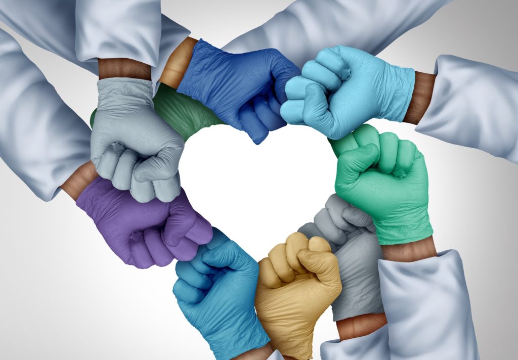 Medical staff unity and doctors working together and medical teamwork or health workers unity and global healthcare partnership as a group of diverse medics connected together shaped as a heart in a 3D illustration style.