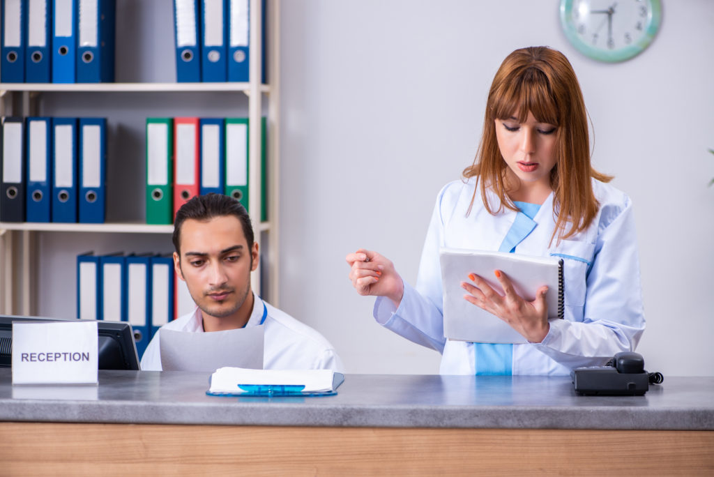 The two doctors working at the reception in the hospital